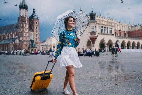 A woman walks around with a suitcase
